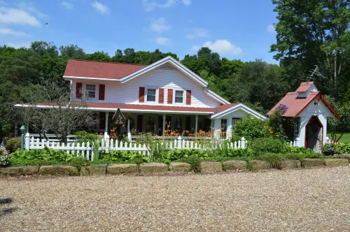 Restored Historical Farmhouse With Pond And Farm Animals At Mohican State Park