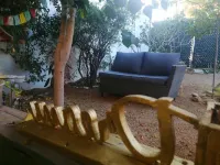 An amazing apartment with green area, garden with teable and chairs in the best
