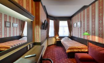 a modern hotel room with red and gold walls , a large window , and a bed at Hotel Berg