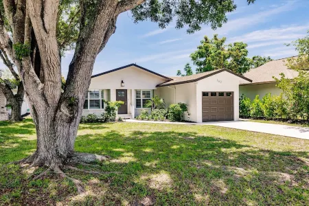 Chic Coastal Bungalow with Fire Pit, Lanai, Games & Fully Fenced Yard