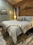The Cozy Pines is a newly built, romantic log cabin with a 2-sided fireplace.