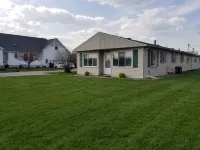 Open concept 2 bedroom ranch with attached garage and deck