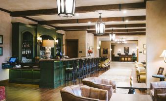 a large hotel lobby with a bar and several chairs arranged in front of it at Hotel Viata