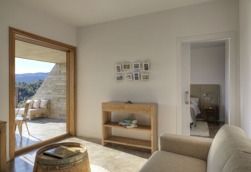 a room with a wooden bookcase and a sliding glass door leading to an outdoor area at Trossos del Priorat