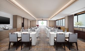 A spacious room with long tables and chairs is available for meetings or other business purposes at Holiday Inn & Suites Sanya Yalong Bay