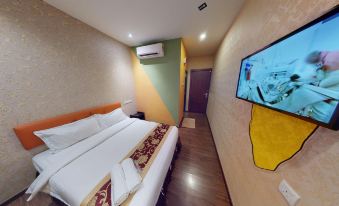 a hotel room with a king - sized bed , an air conditioner , and a flat - screen tv mounted on the wall at Hamilton Hotel Kajang