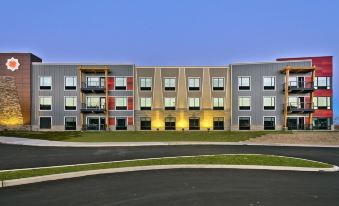 a modern , multi - story building with a gray exterior and multiple balconies under a clear blue sky at Shoshone Rose Casino & Hotel