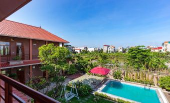 a beautiful backyard with a swimming pool , trees , and a red - tiled roof , as well as a view of the surrounding area at MH Cherish Homestay