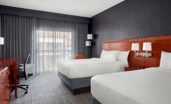 a hotel room with two beds , one on the left and one on the right side of the room at Courtyard Philadelphia Valley Forge/King of Prussia
