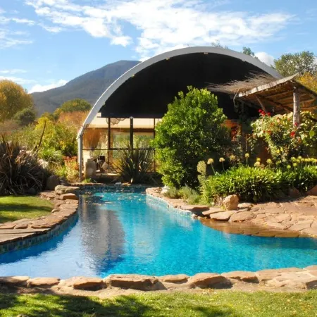 Tree Tops Apt @ Dreamers features log fire, mountain + pool views thru tree tops