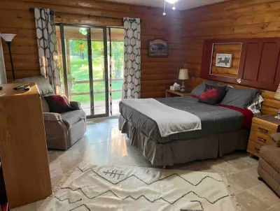 Log Cabin house on 10.5 acers of wooded land. Accommodates 20 plus guest.