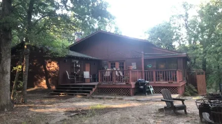 Private lakefront getaway with a sandy beach below the back deck!