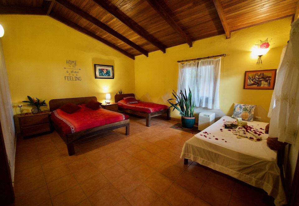 a room with two beds , one on the left side and the other on the right side of the room at El Mirador Glamping & Apartments & Woodhouse & Swimingpool