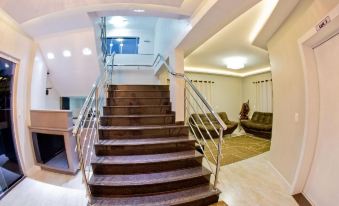 a modern home with a staircase leading to the second floor , and a couch in the living room at North Hotel - Aeroporto