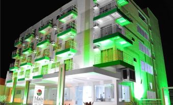 "a modern building with multiple floors , green lights , and a sign that says "" mar "" in front of it" at Maison Hotel