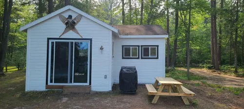 Serene cottage on private lake! Enjoy a private dock, fire pit, canoe, & more!