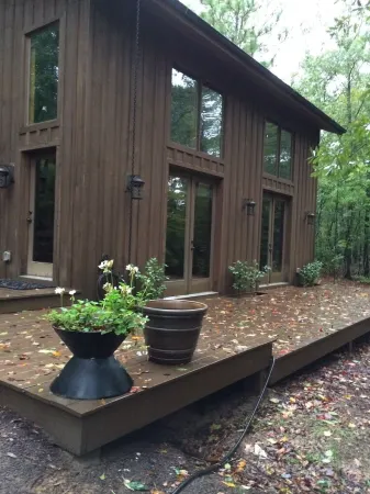 Stunning and private mid-century modern inspired cottage nestled in the woods.