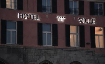 "a brick building with a sign that reads "" hotel de ville "" prominently displayed on the side of the building" at Hotel de Ville