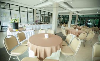 a dining room with tables and chairs arranged for a large group of people to enjoy a meal together at MaiHom Villa