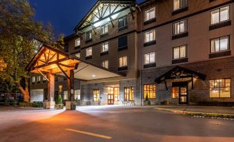 a large hotel building with a parking lot in front of it , illuminated at night at The Inn at GIG Harbor
