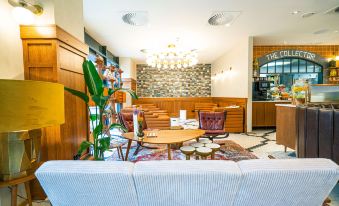 a modern hotel lobby with a reception desk , couches , and chairs arranged in an open space at The Collector