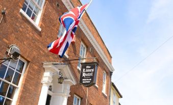 "a building with a union jack flag flying from its window , and a sign that reads "" love back "" is visible" at Limes Hotel