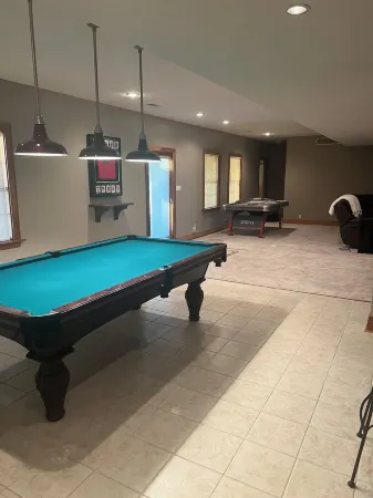 Fully custom modern four bedroom home on 13 acres with a stocked pond.