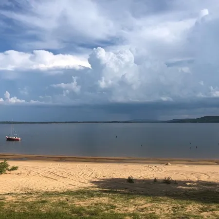 Private lakefront getaway with a sandy beach below the back deck!