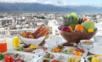 a dining table with a variety of food items , including bread , fruits , and other dishes at Hotel Buena Vista