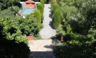 a bird 's eye view of a house with a pool and surrounding greenery in the backyard at Casa Montes