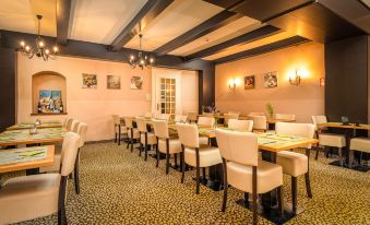 a dining room with several tables and chairs arranged for a group of people to enjoy a meal together at Hotel Lindenhof