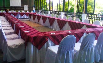 a long dining table set up for a formal event , with multiple chairs arranged around it at Hotel la Riviera de Atitlan