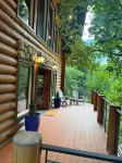Cozy log cabin secluded in a mountain forest with hot tub, sauna, private patio.