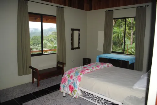 Ocean & mountain vistas, from the porches of this modern jungle perched villa.