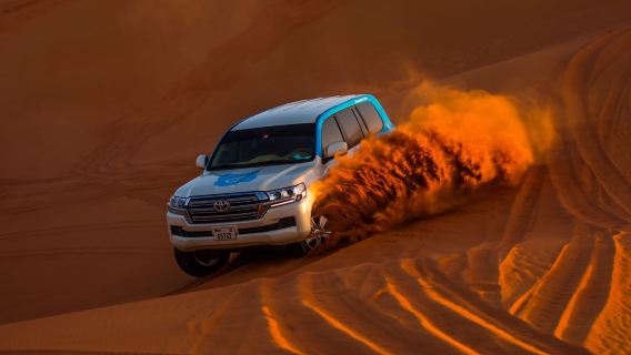 Dubai morning dune bashing and sandboarding, camel riding, hotel pick-up and drop-off in the city center.