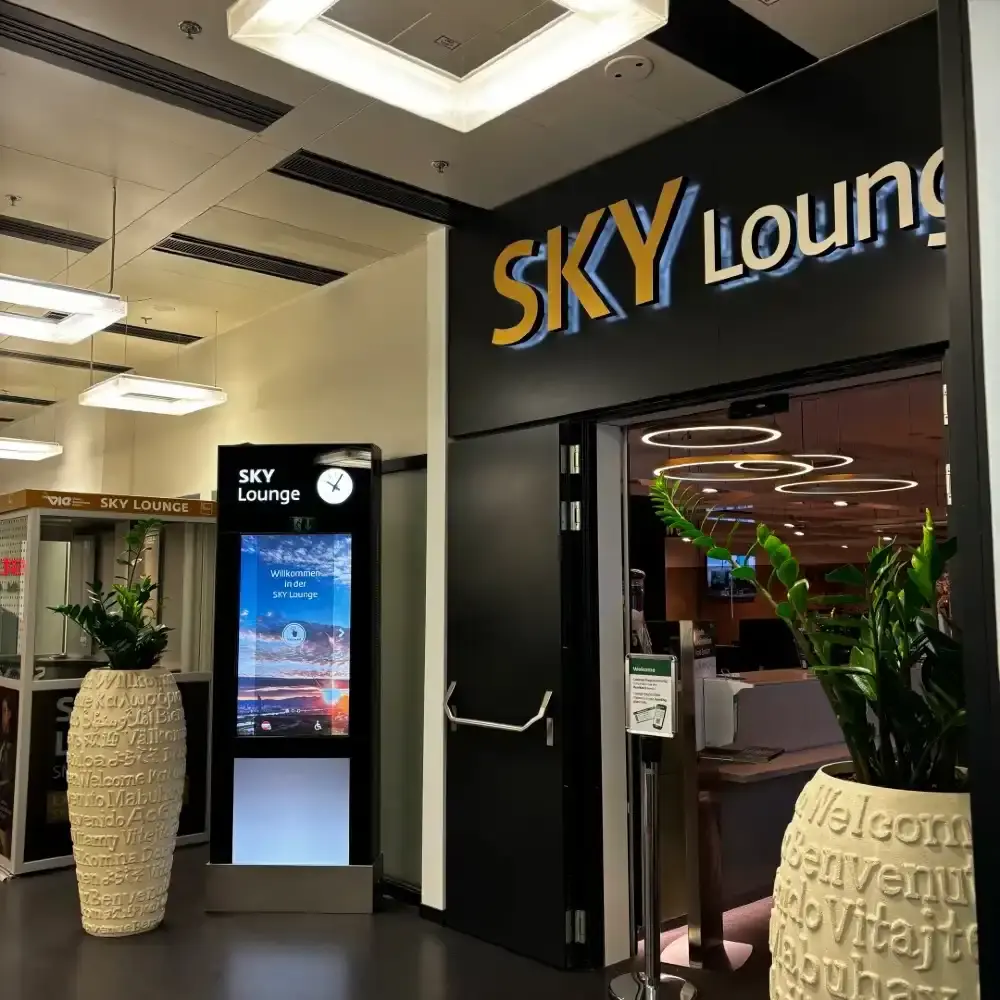 SÂN BAY VIENNA VỚI CẢNH QUAN THÀNH PHỐ PHÍA XA VÀ MÁY BAY ĐANG LĂN BÁNH