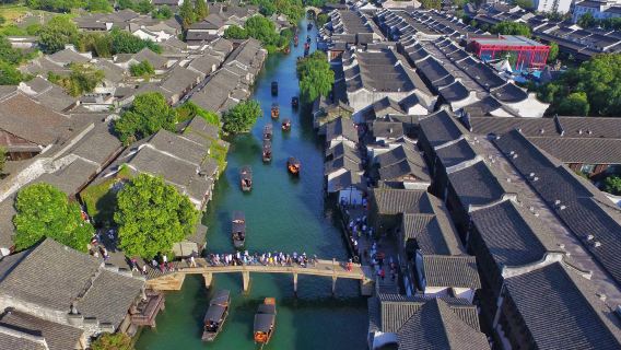Departing from Hangzhou, visit Wuzhen East Gate and Xitang Ancient Town with a Chinese-language group tour.