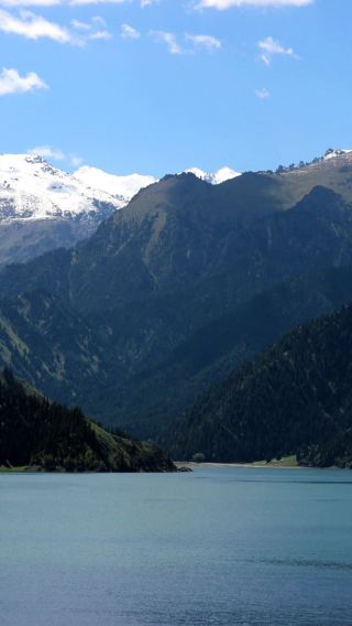 Must-visit in Xinjiang: One-day tour to Tianshan Tianchi from Urumqi | Snow-capped peaks mirroring emerald waters, spruce trees surrounding the heavenly pool