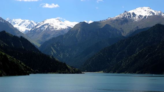 Must-visit in Xinjiang: One-day tour to Tianshan Tianchi from Urumqi | Snow-capped peaks mirroring emerald waters, spruce trees surrounding the heavenly pool