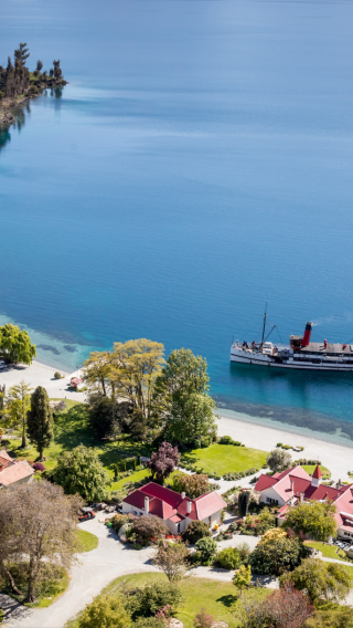 Iconic activity in Queenstown, New Zealand: century-old steamship + highland farm sheep shearing show + buffet