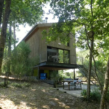 Wooden house in the golf, between forest, lake and ocean
