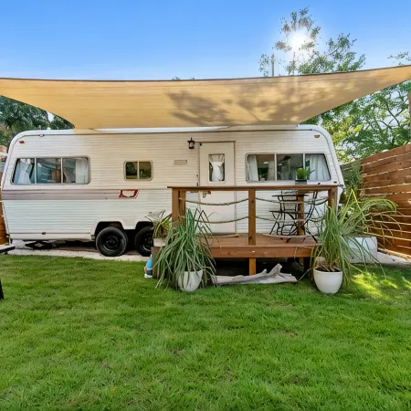 Renovated 1970’s retro camper on Bayou Grande in Pensacola with walking trail.