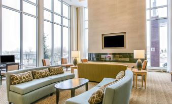 a large , well - lit room with multiple couches and chairs arranged around a coffee table , creating a cozy and inviting atmosphere at Wyndham Avon