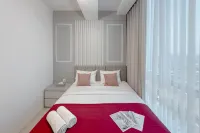 Combined Grey Toned 2BR Apartment at The City Square Surabaya By Travelio