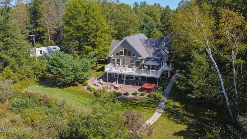 "Home Away From Home" nestled into five private acres on an all sports lake!