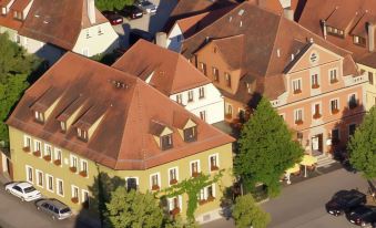 an aerial view of a residential area with multiple buildings , some of which have red roofs at Akzent Hotel Schranne