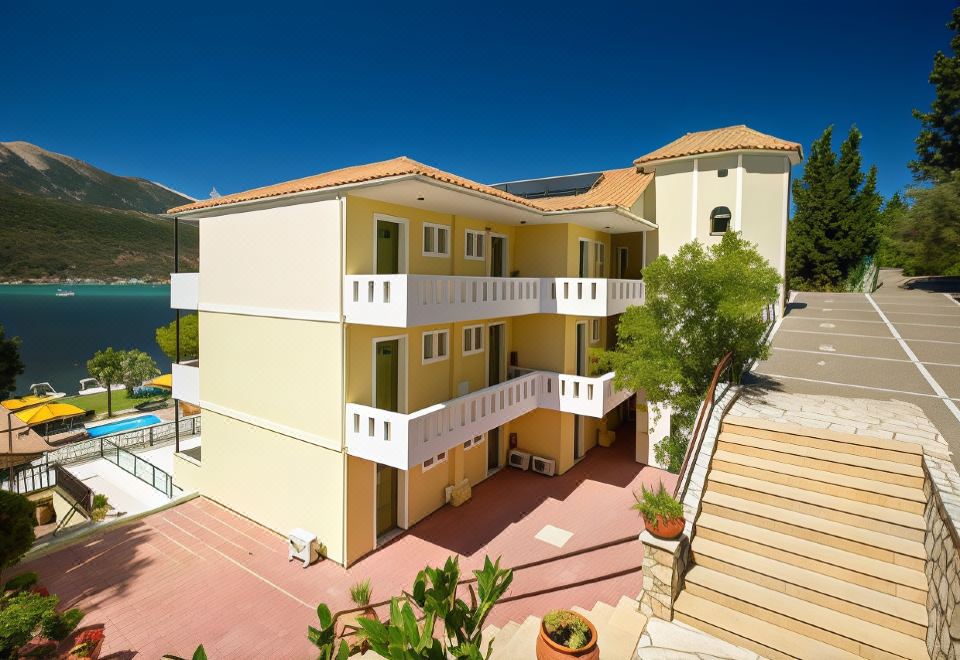 a multi - story building with balconies and a pool is surrounded by trees and a clear blue sky at Cleopatra Beach