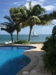 Quiet and serene ocean front 2-bedroom 2-bathroom condo, steps from the sand!