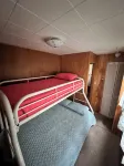 Charming 2-bedroom cabin sits on 2.5 acres on Hubbard Lake.