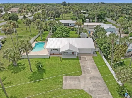 Indian River Waterfront Home with private dock, heated pool, fenced back yard